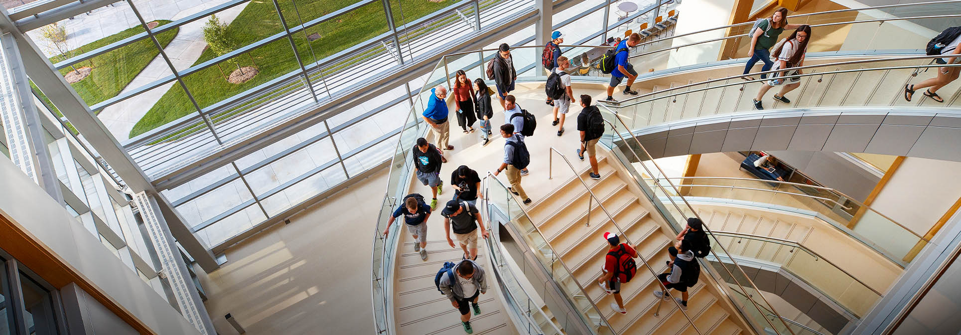 downward view of a staircase with students walking up and down